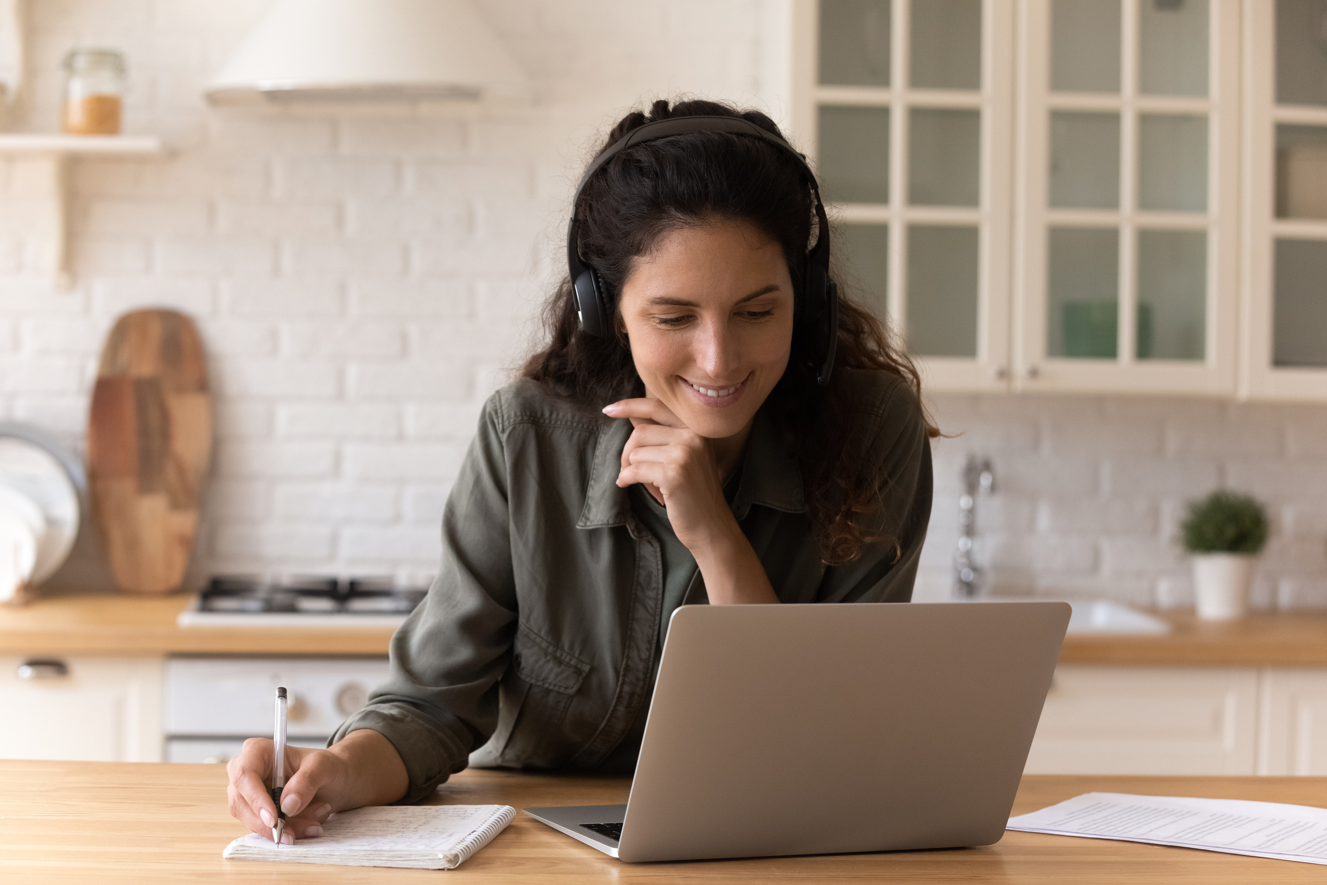 Smiling millennial woman watch webinar on laptop